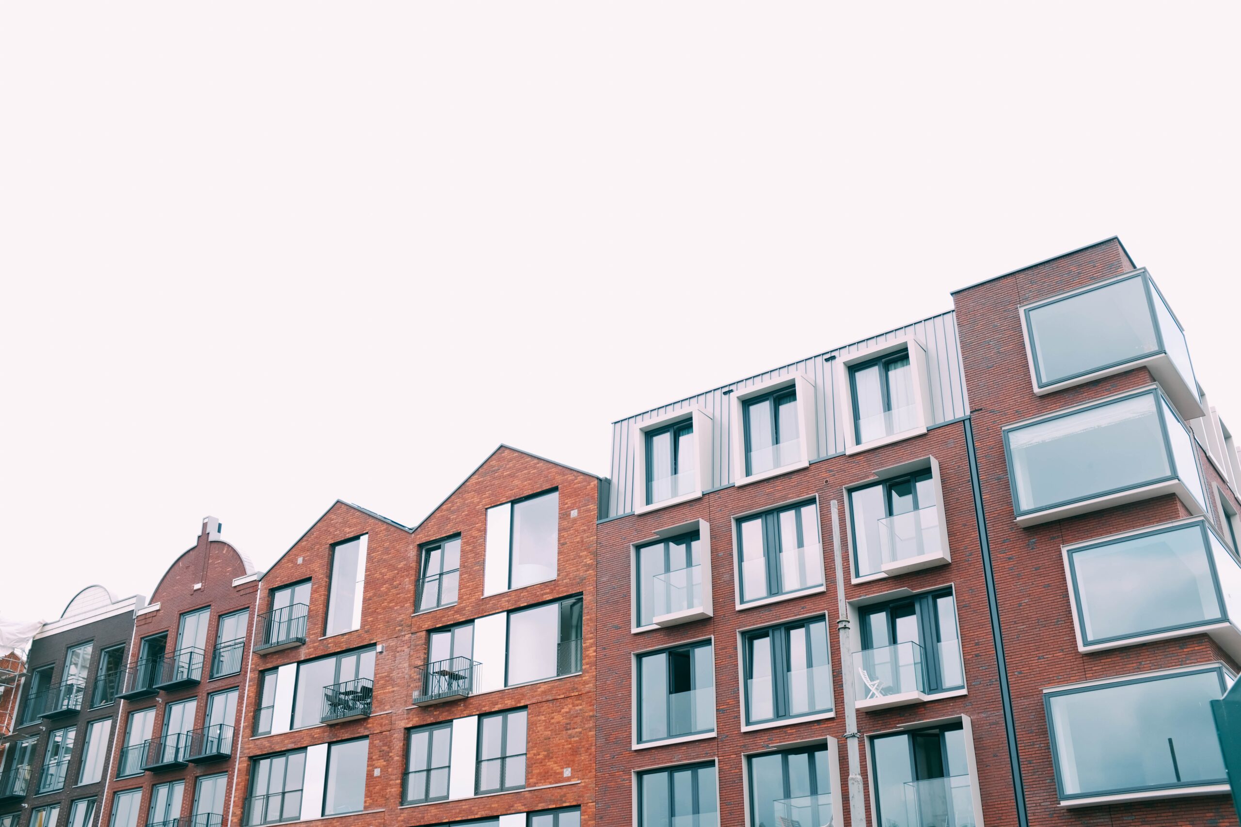 A low angle shot of a concrete brown building under the white sky